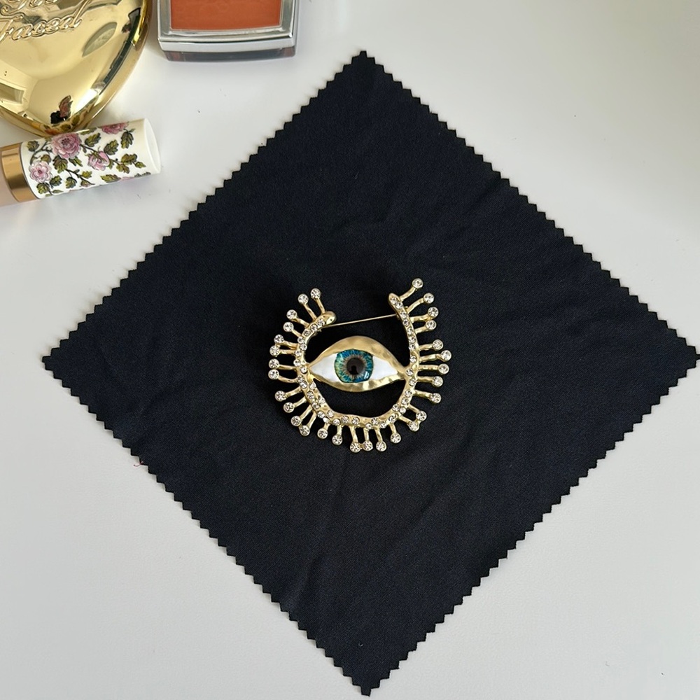 Gold and Blue Eye Brooch